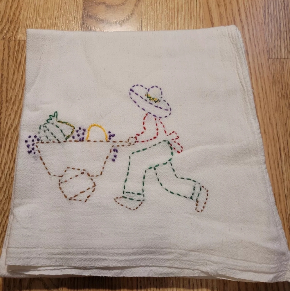 Lady Pushing Wheelbarrow Tea Towel Embroidered or Hand Stitched?